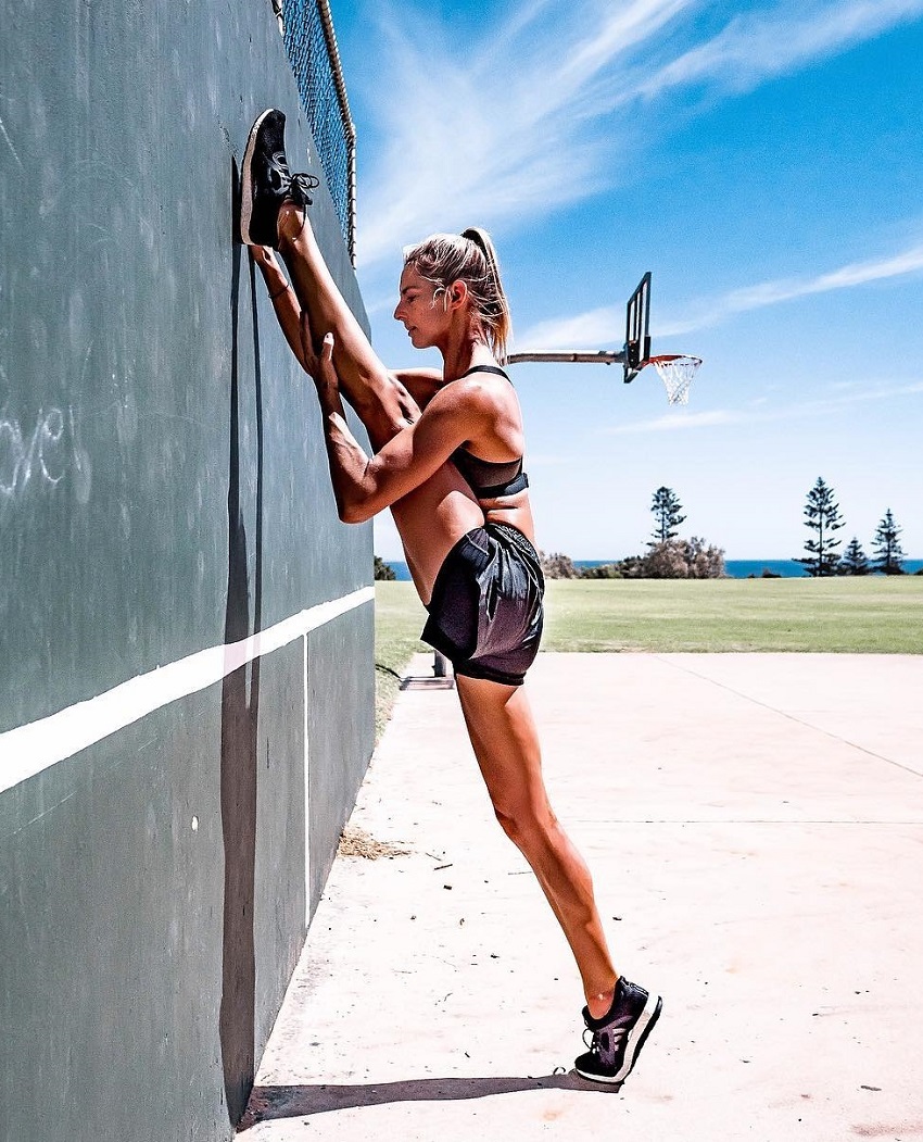 Amanda Bisk stretching her legs outdoors