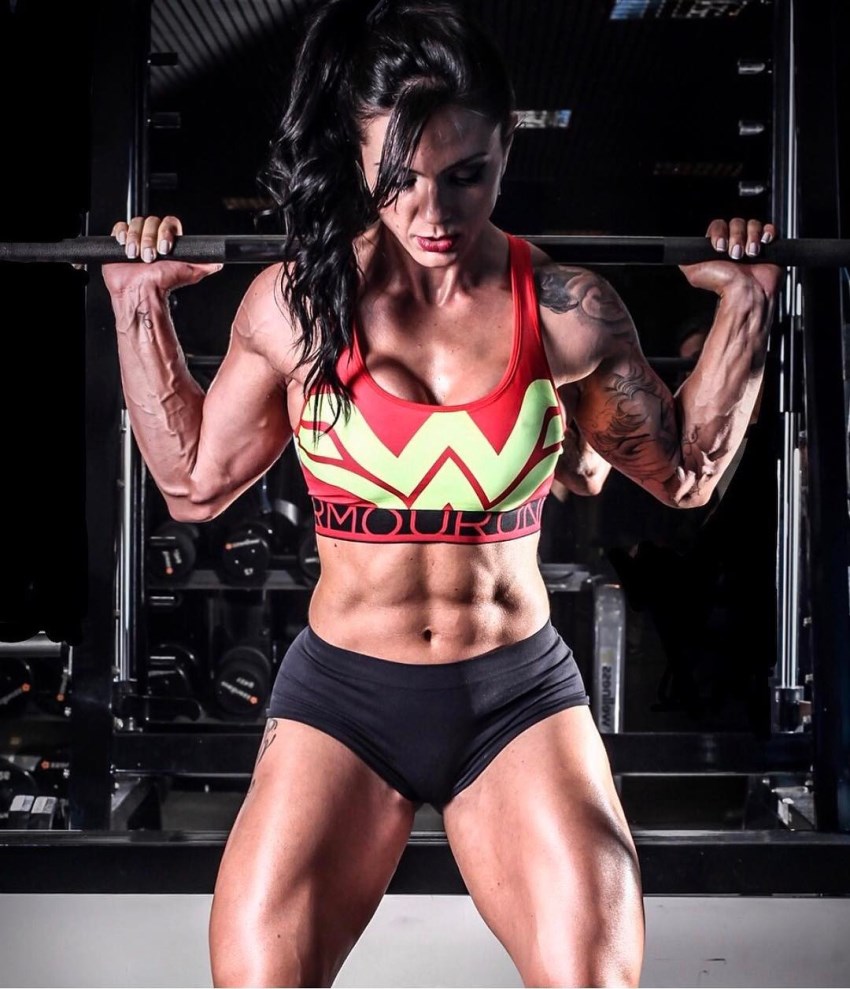 Renata Costa doing squats in a gym looking strong and fit