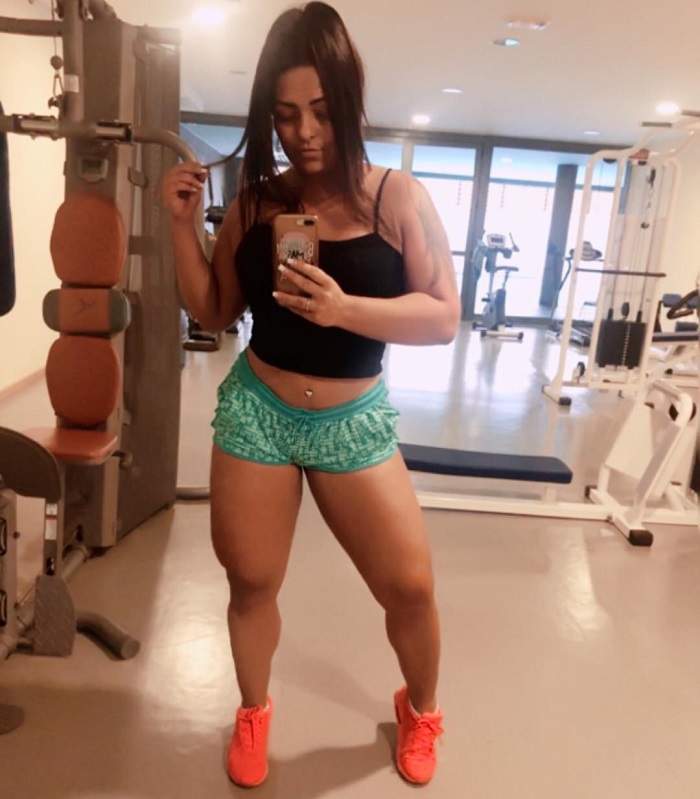 Andressa Soares taking a selfie of her muscular and fit legs